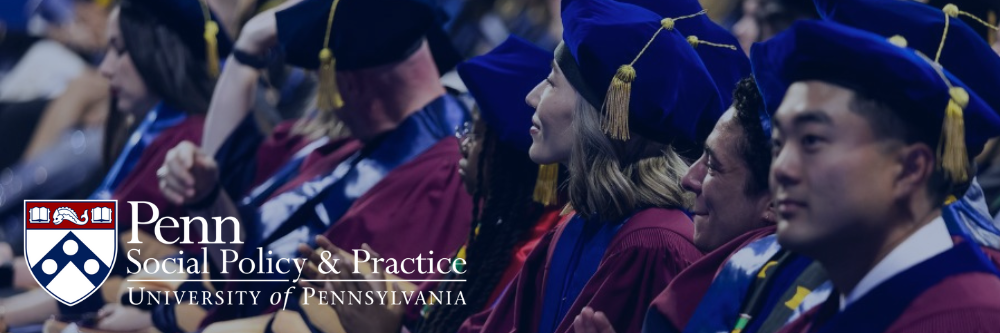 PhD graduates sit in a row during the commencement ceremony