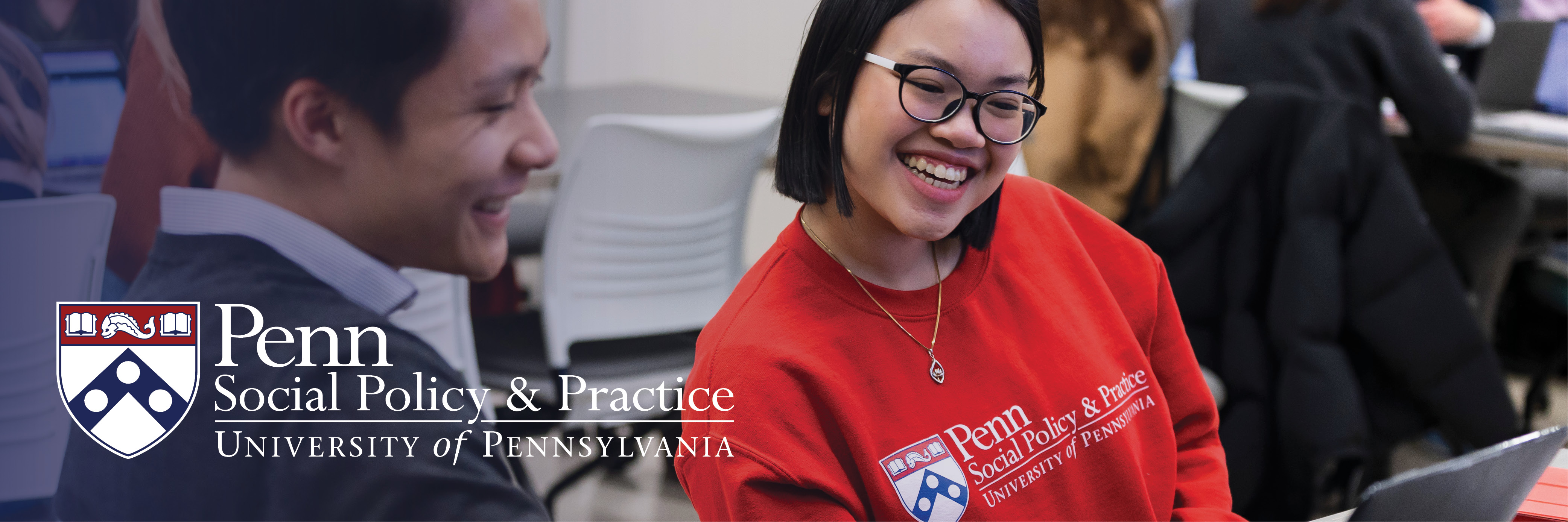 Students look at a laptop together